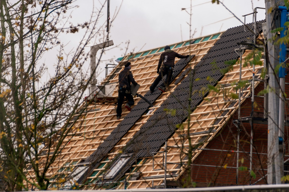 two men installing a new roof